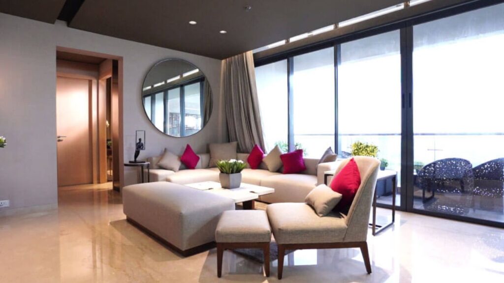 The spacious and naturally lit living and dining area inside a 4 BHK luxury apartment at PS Aurus Kolkata, showcasing premium finishes suitable for high-end premium residences.